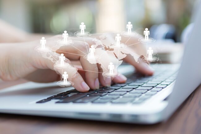 Closeup of business woman hand typing on laptop keyboard